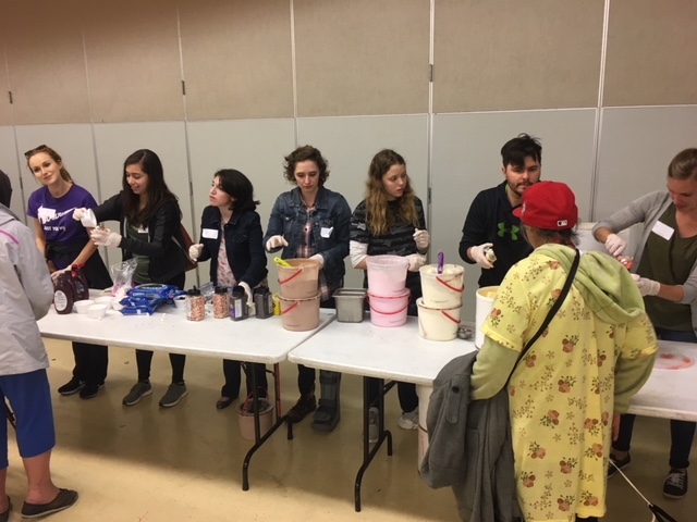 volunteers serve ice cream to homeless