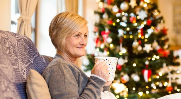 Woman with coffee and Christmas tree